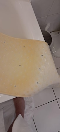 Dirty and discoloured bath mat