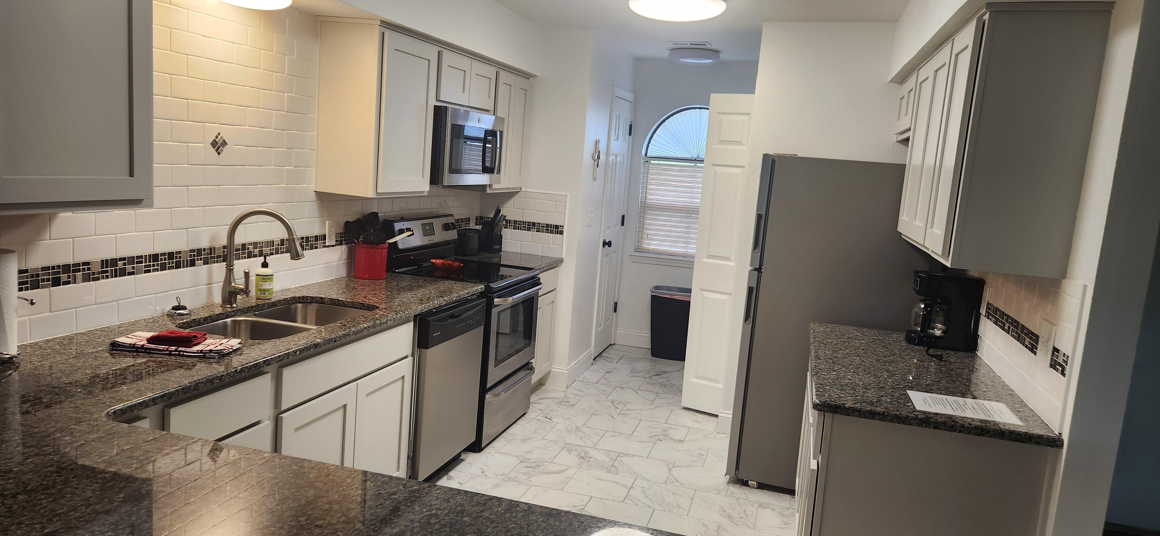 Spacious fully stocked kitchen.