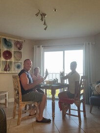 Dining at the condo with an oceanfront view- full kitchen. We cooked fresh catch fish
