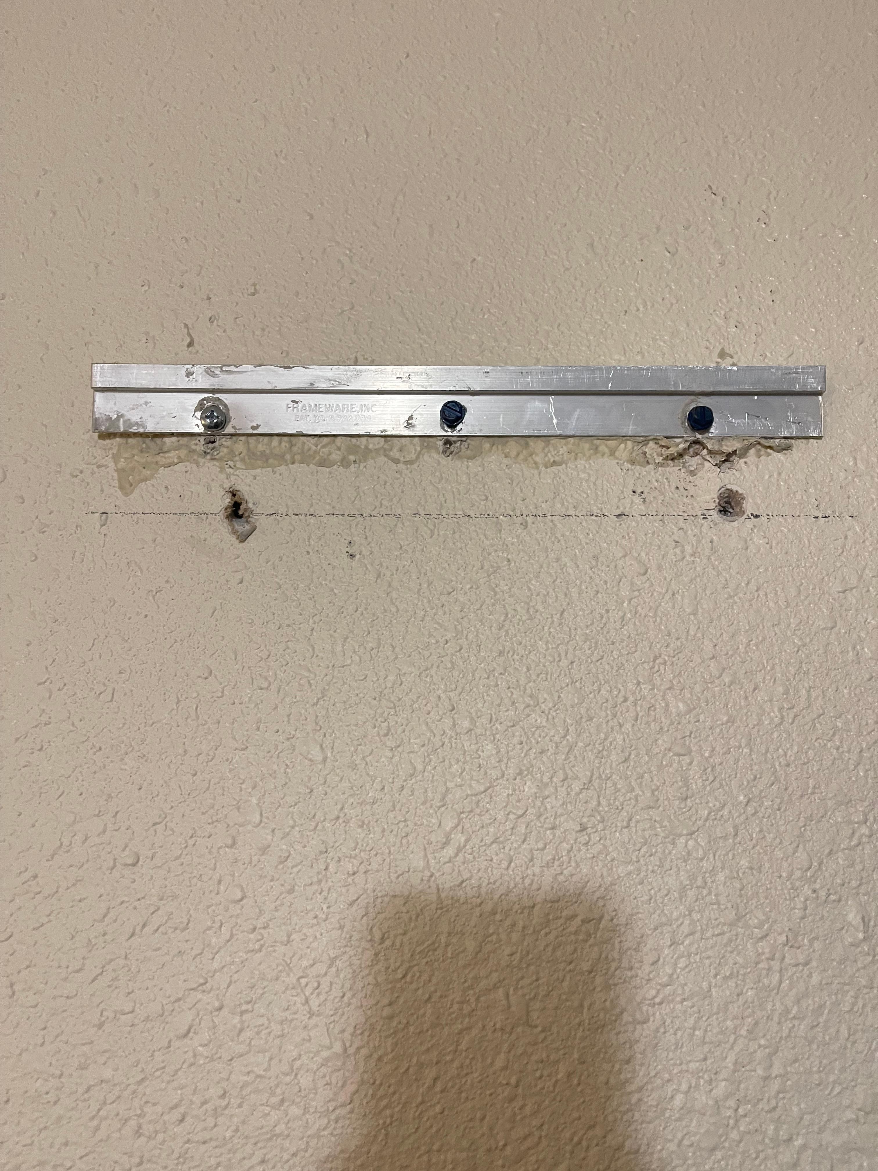 In the wall behind main door