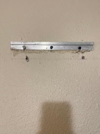 In the wall behind main door