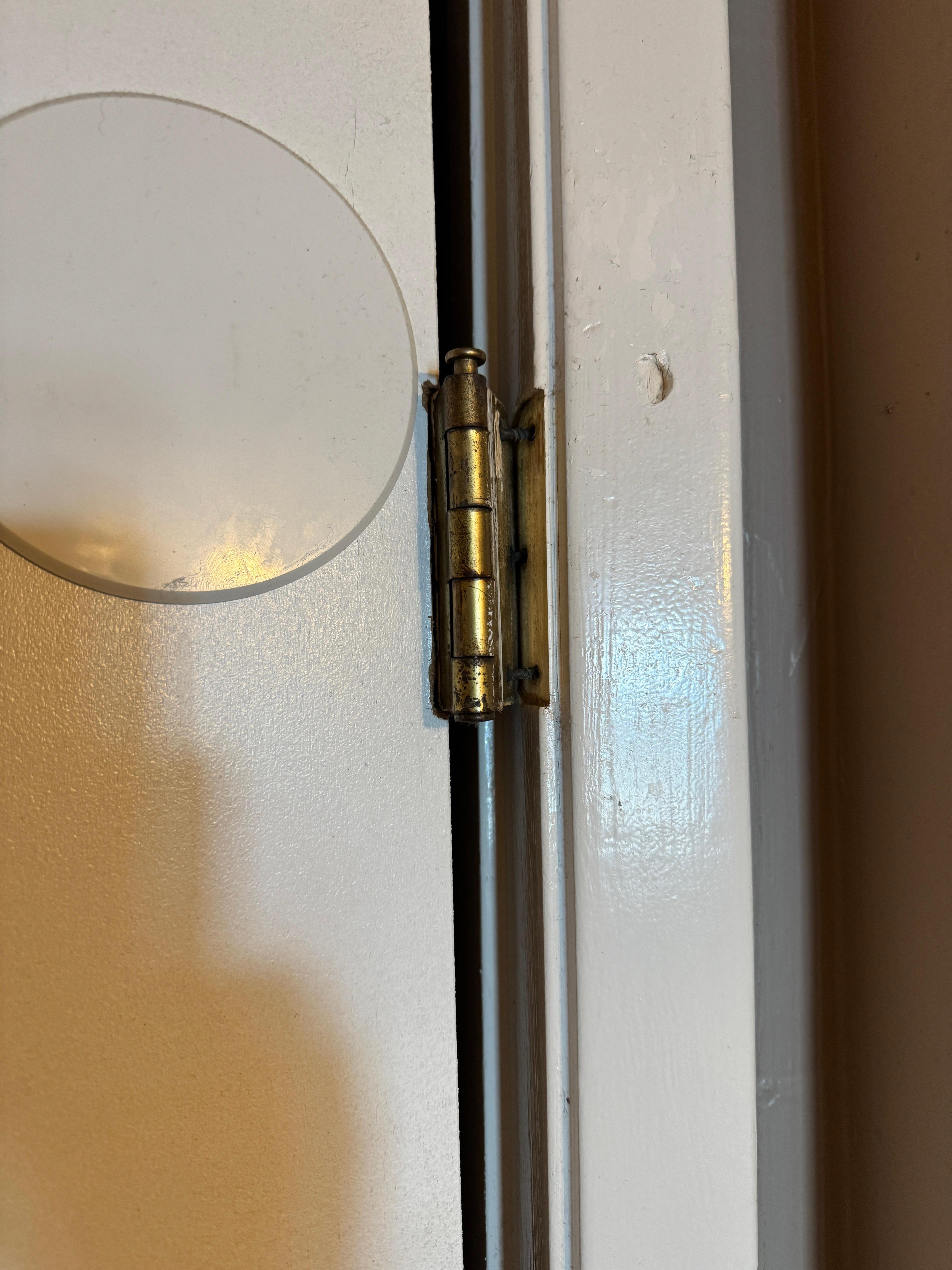 Master bedroom door hanging by one hinge.