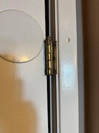 Master bedroom door hanging by one hinge.