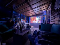 Outdoor, enclosed, covered patio movie night.