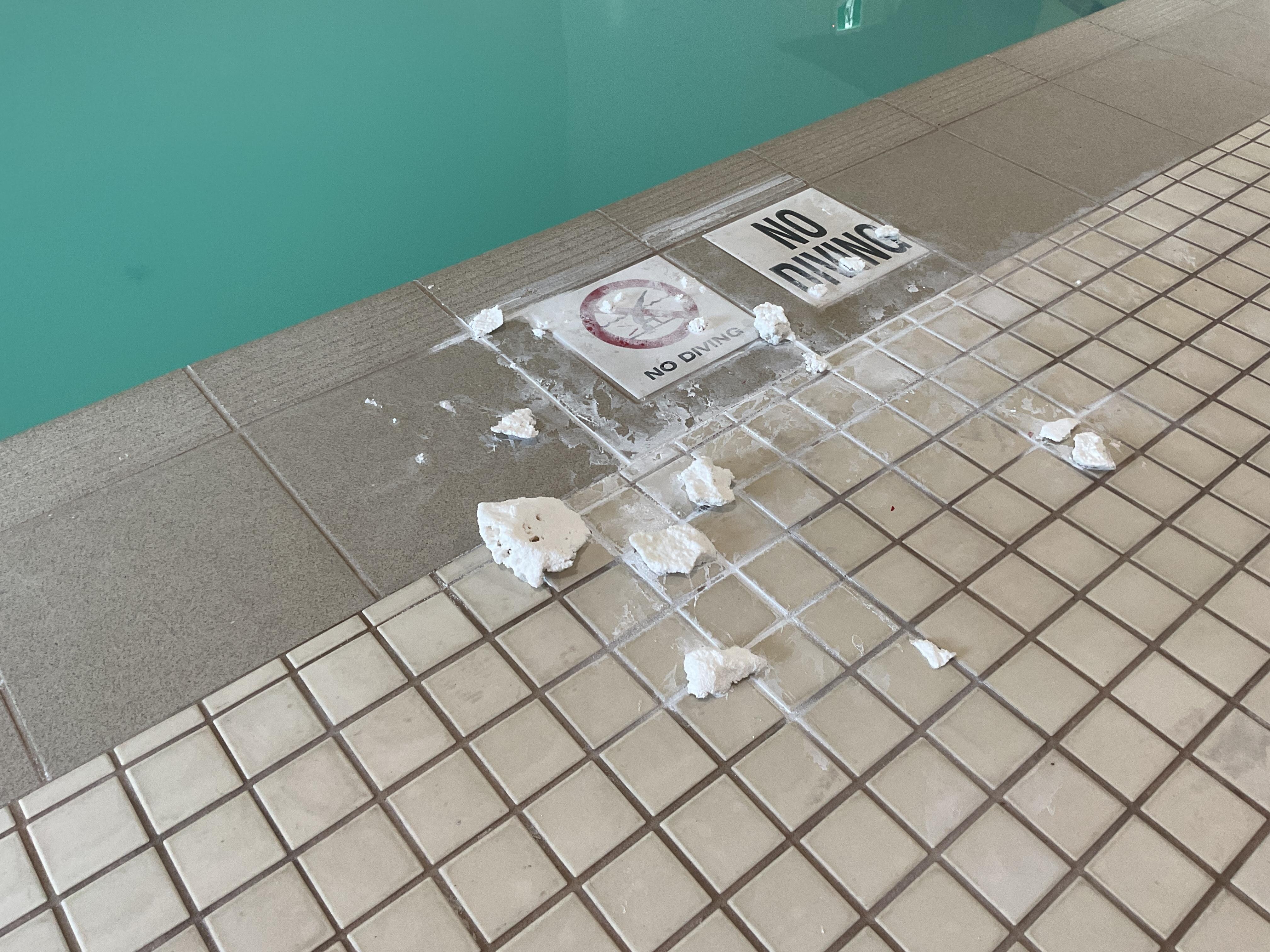 Substance by pool.  Not cleaned up in a timely manner.
