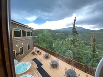 Absolutely beautiful view from the lodge, where you can see the mountains as well as the hot tubs and more outdoor seating.