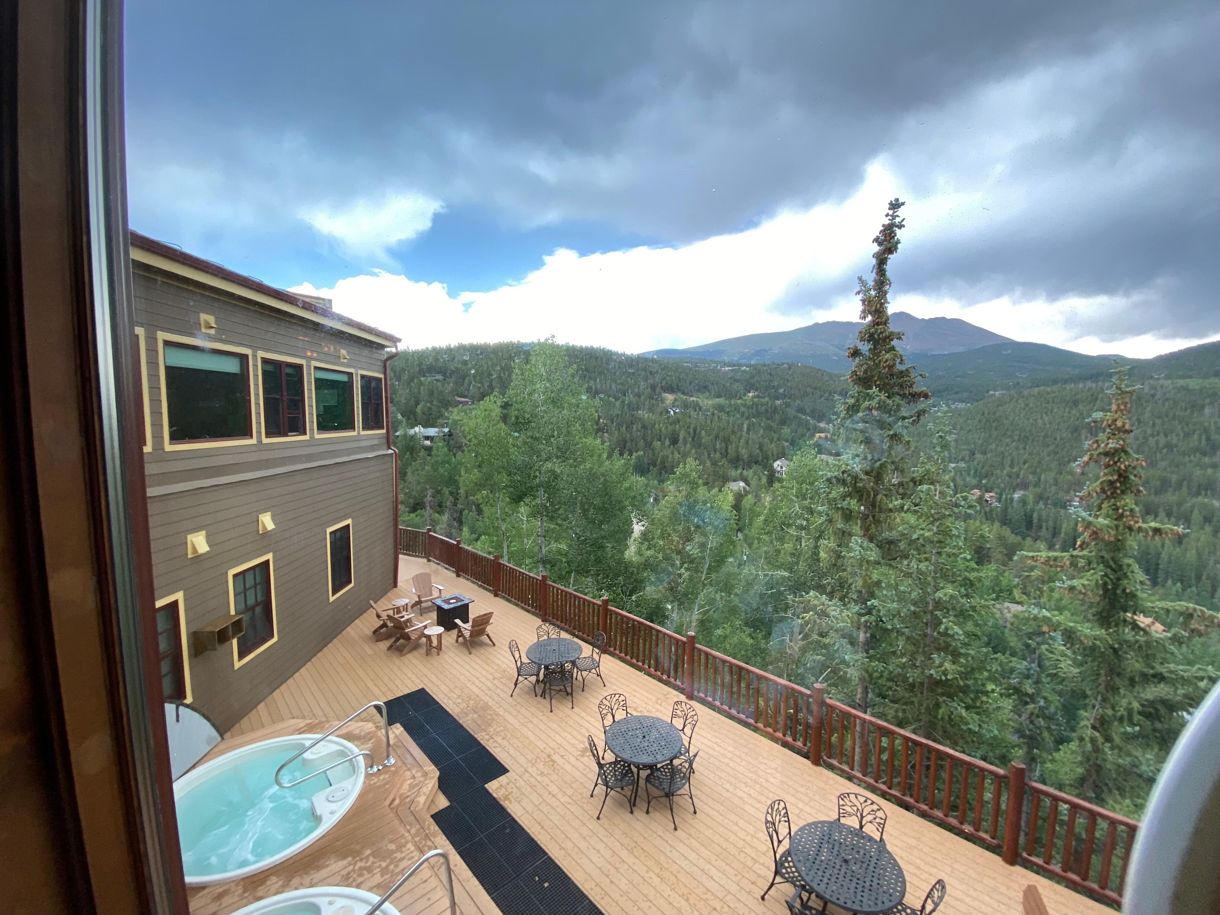 Absolutely beautiful view from the lodge, where you can see the mountains as well as the hot tubs and more outdoor seating.