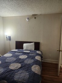 Smoke detector hanging by wires. Bed looked tidy, but I wasn't brave enough to pull back the covers after seeing bugs in the air conditioner unit