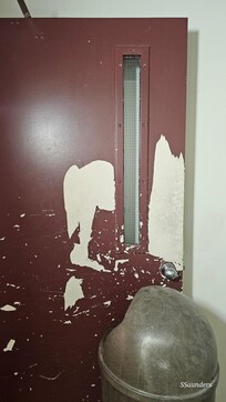 Door on the 2nd floor in need of repair.