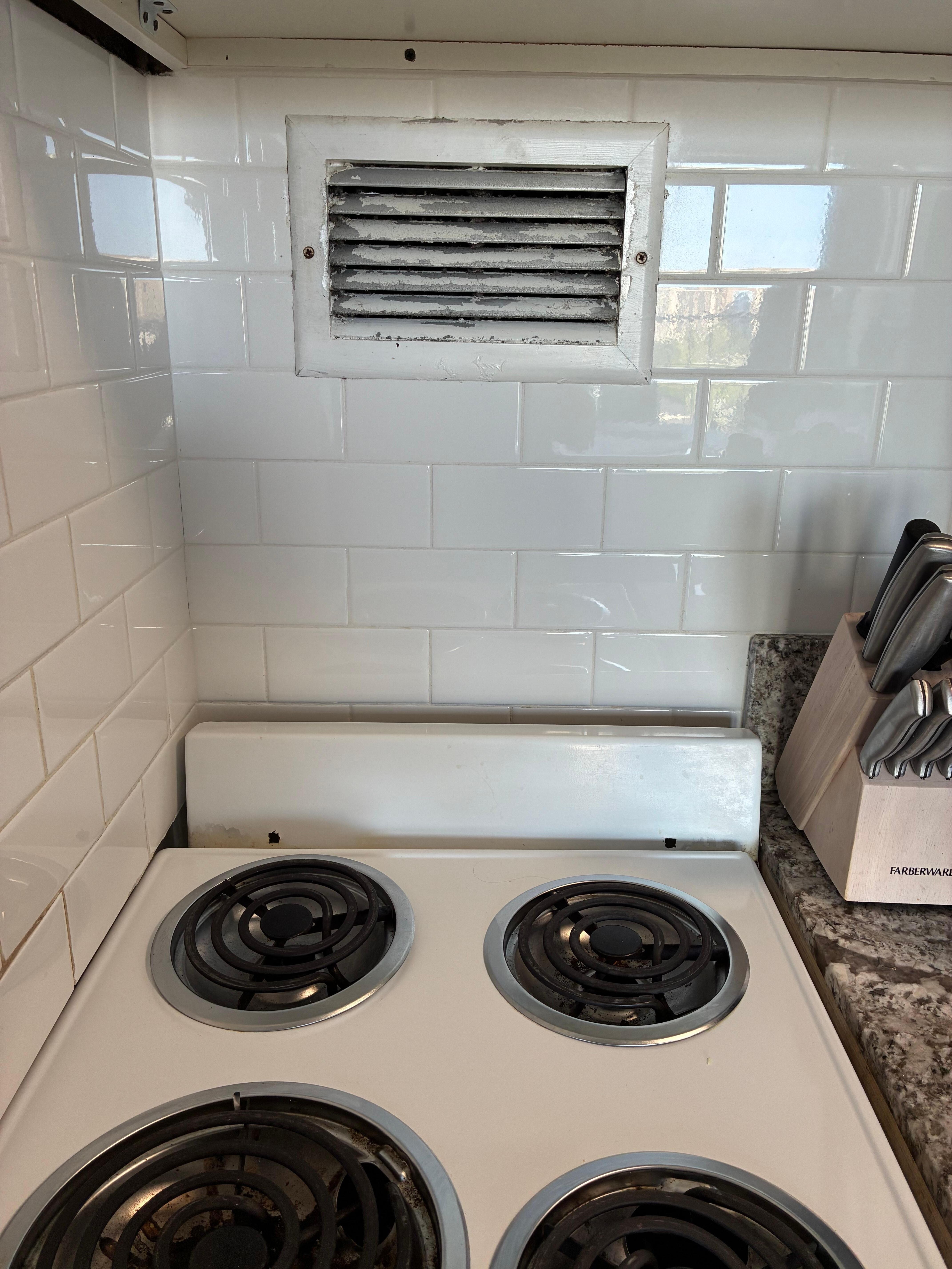 Massive paint peeling off vent over stove.