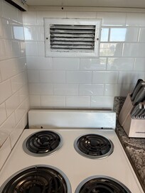 Massive paint peeling off vent over stove.