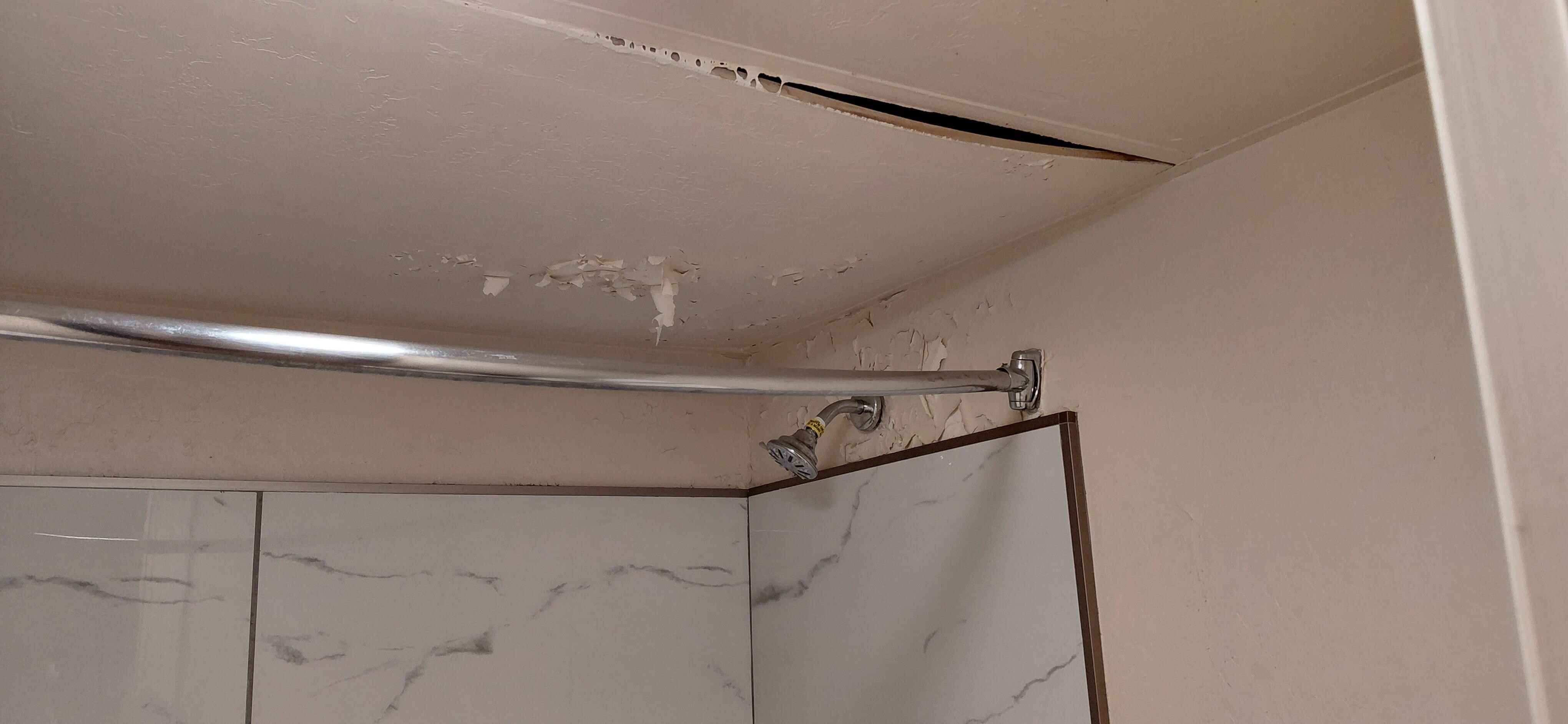 Water damage above the tub. There was more damage near the bottom of the wall.