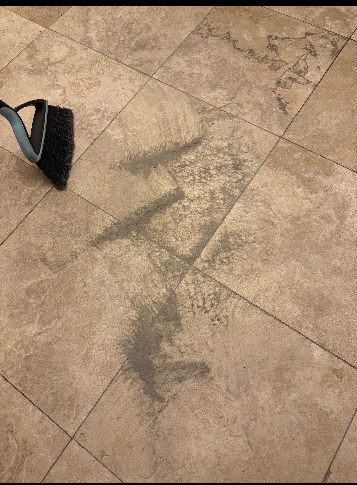 Sand and dirt under kitchen rug.