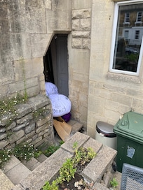 Laundry and garbage under stairs