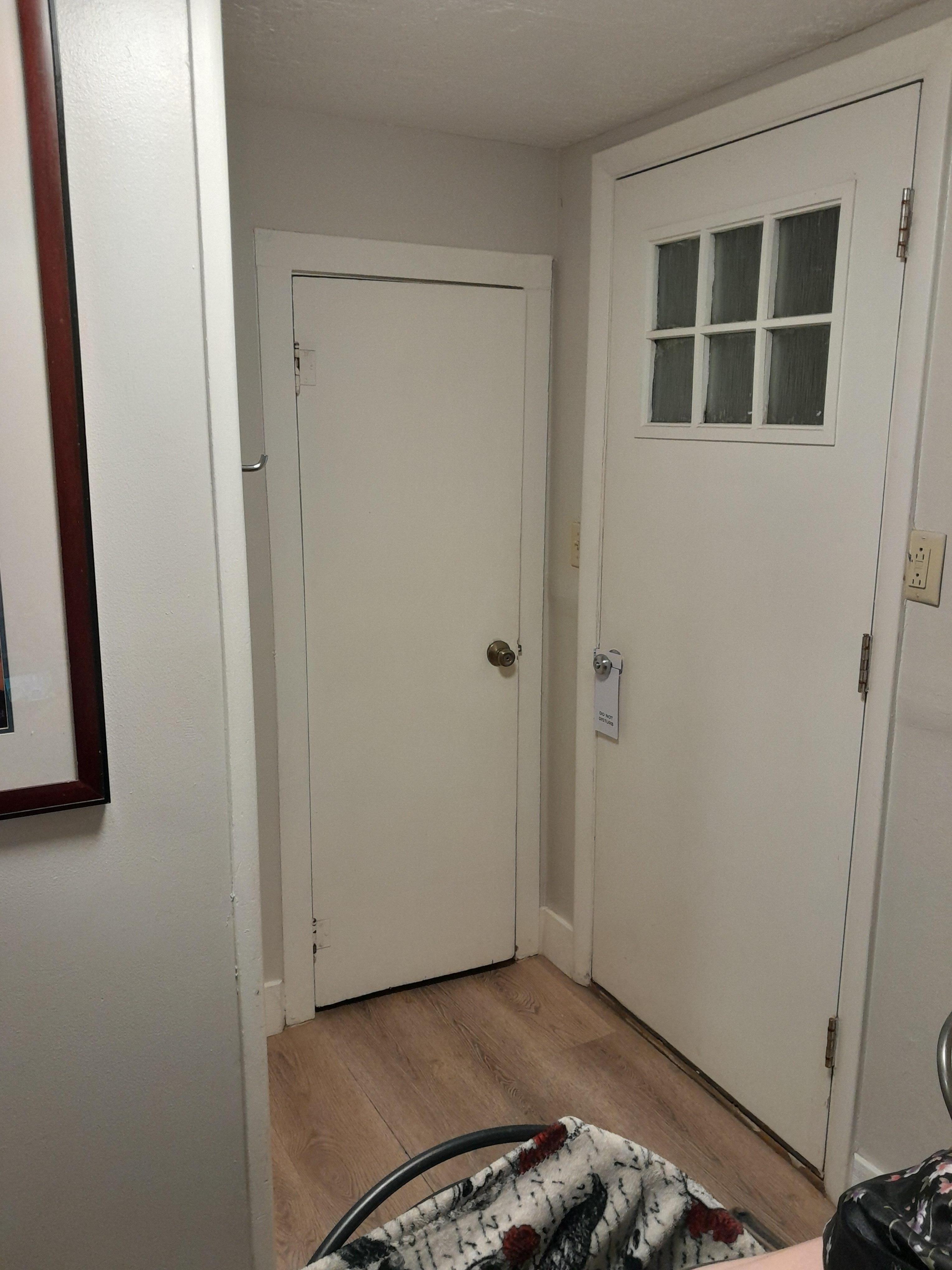 Bathroom area from the middle room. Big door goes outside, little door is the toilet closet. Shower is the bump out. Sink to the left. 