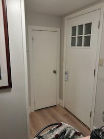 Bathroom area from the middle room. Big door goes outside, little door is the toilet closet. Shower is the bump out. Sink to the left.