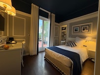 Room 203 (standard double). Peaked into Room 204 which is bigger and has a separate twin bed area alongside the larger space. Big veranda too!