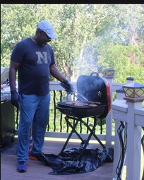 My brother grilling. We brought our own grill because my brother doesn't Iike gas grill.
