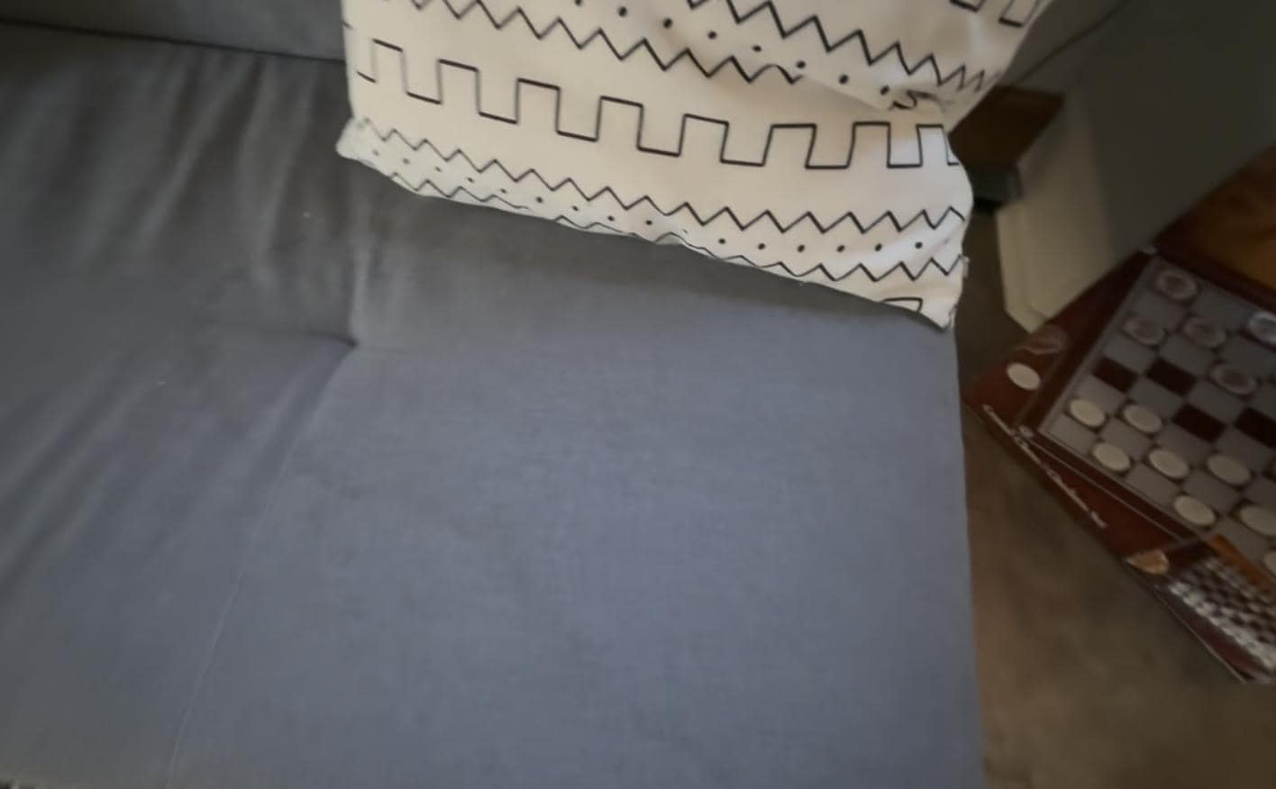 Stained fabric on futon and one of the two mouse traps placed on the floor halfway into our stay