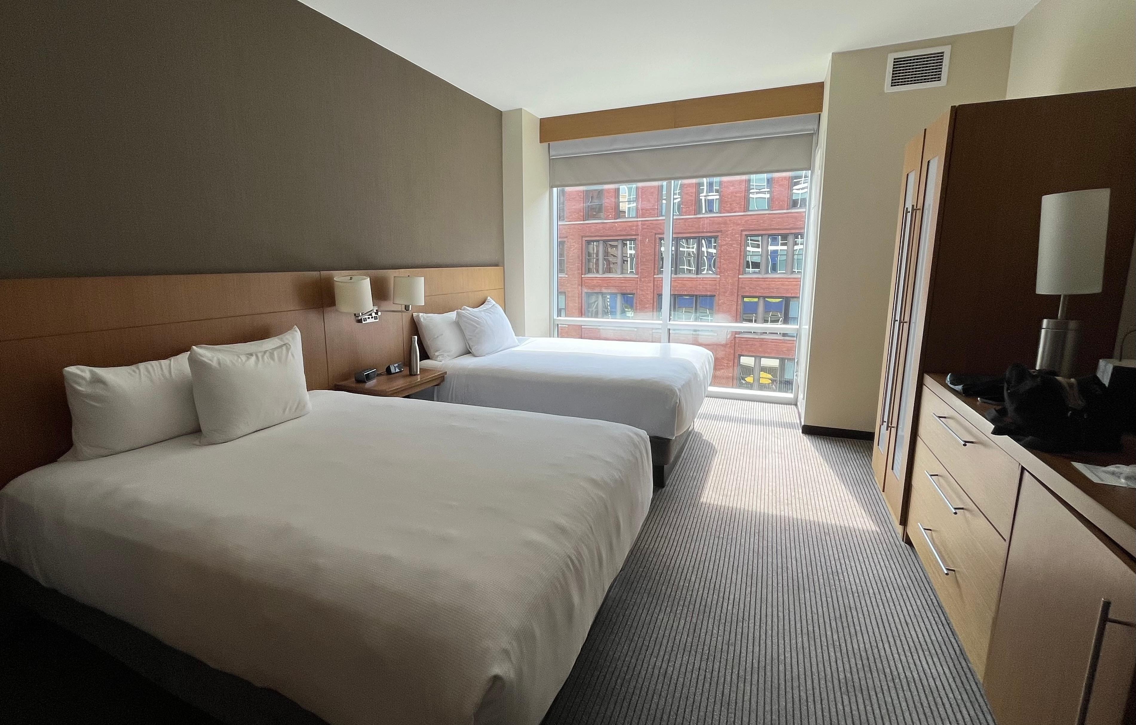 Spacious room, with a seating area, well-appointed bathroom, and a safe.