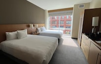 Spacious room, with a seating area, well-appointed bathroom, and a safe.