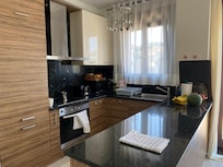 Kitchen with oven, microwave, all the pots, pans, utensils and cutlery that we needed to make family meals. Large fridge and freezer