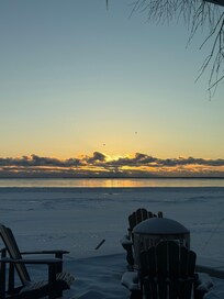 The sunrise from the living room window and caught a couple birds flying by❤️