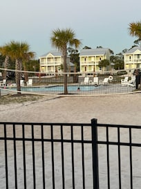 Volleyball court and pool from back porch.