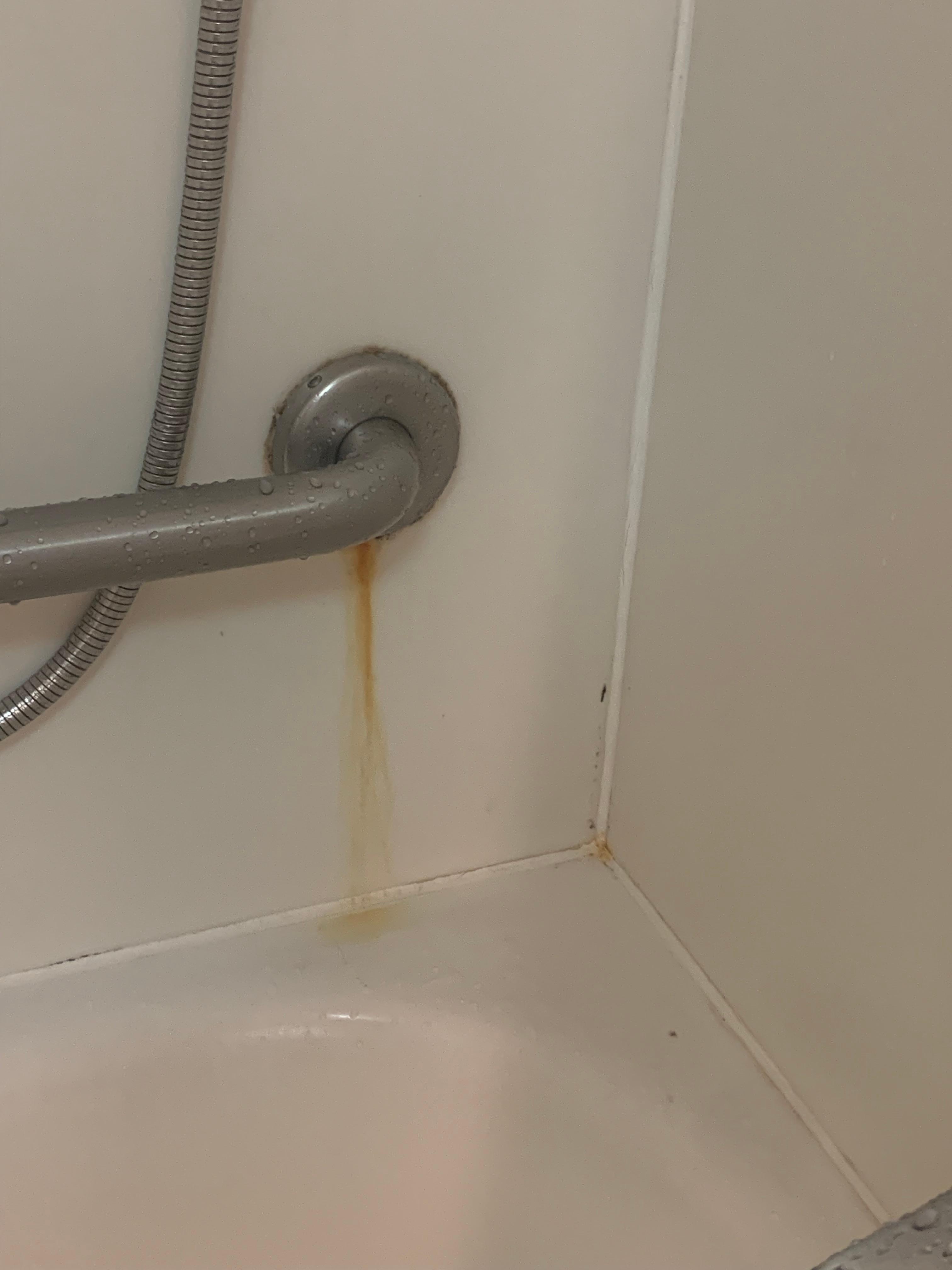 Rust stain below tub handle