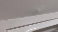 Ceiling in bathroom has water damage from room above