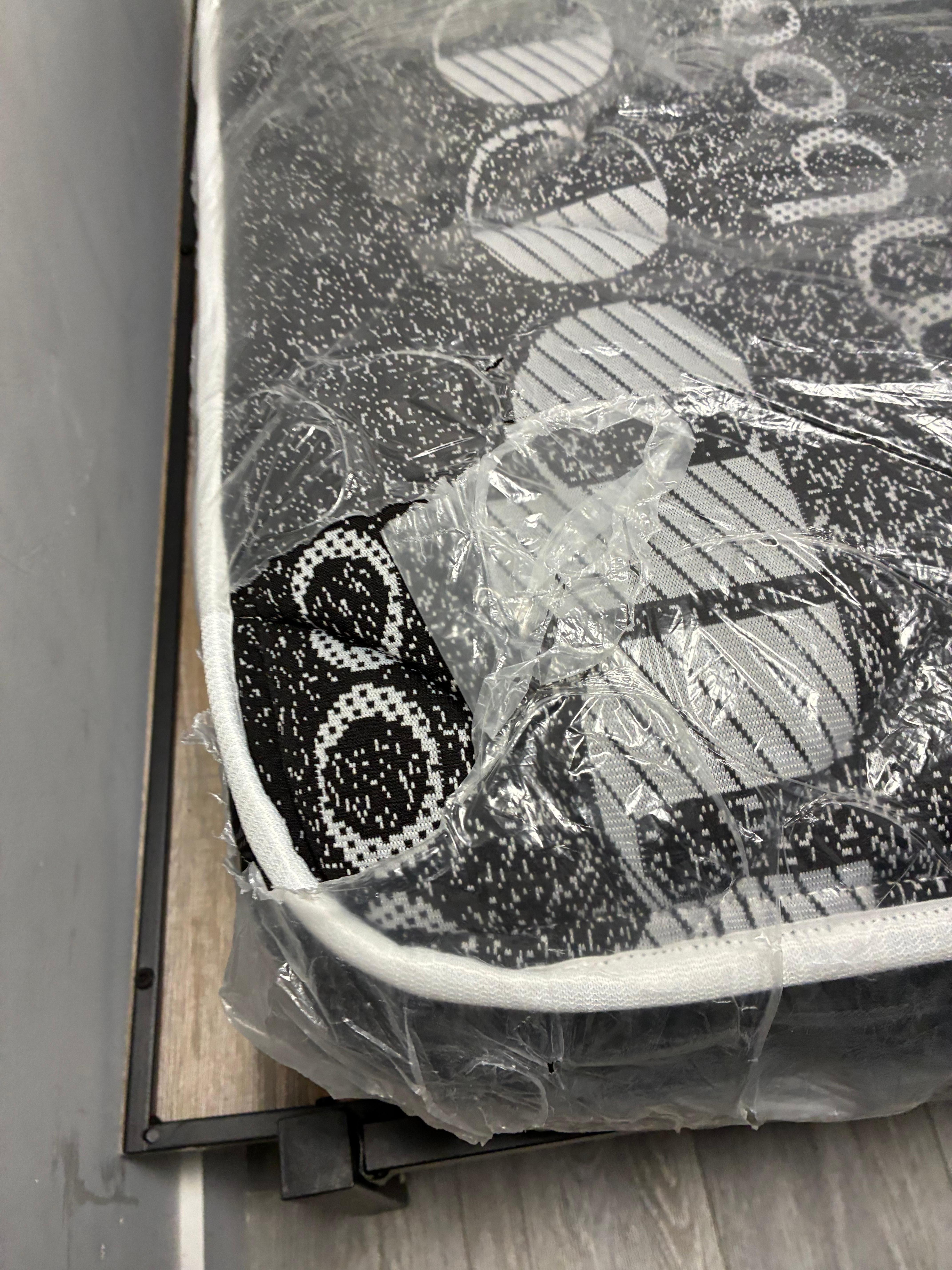 Mattresses are covered in ripped plastic 