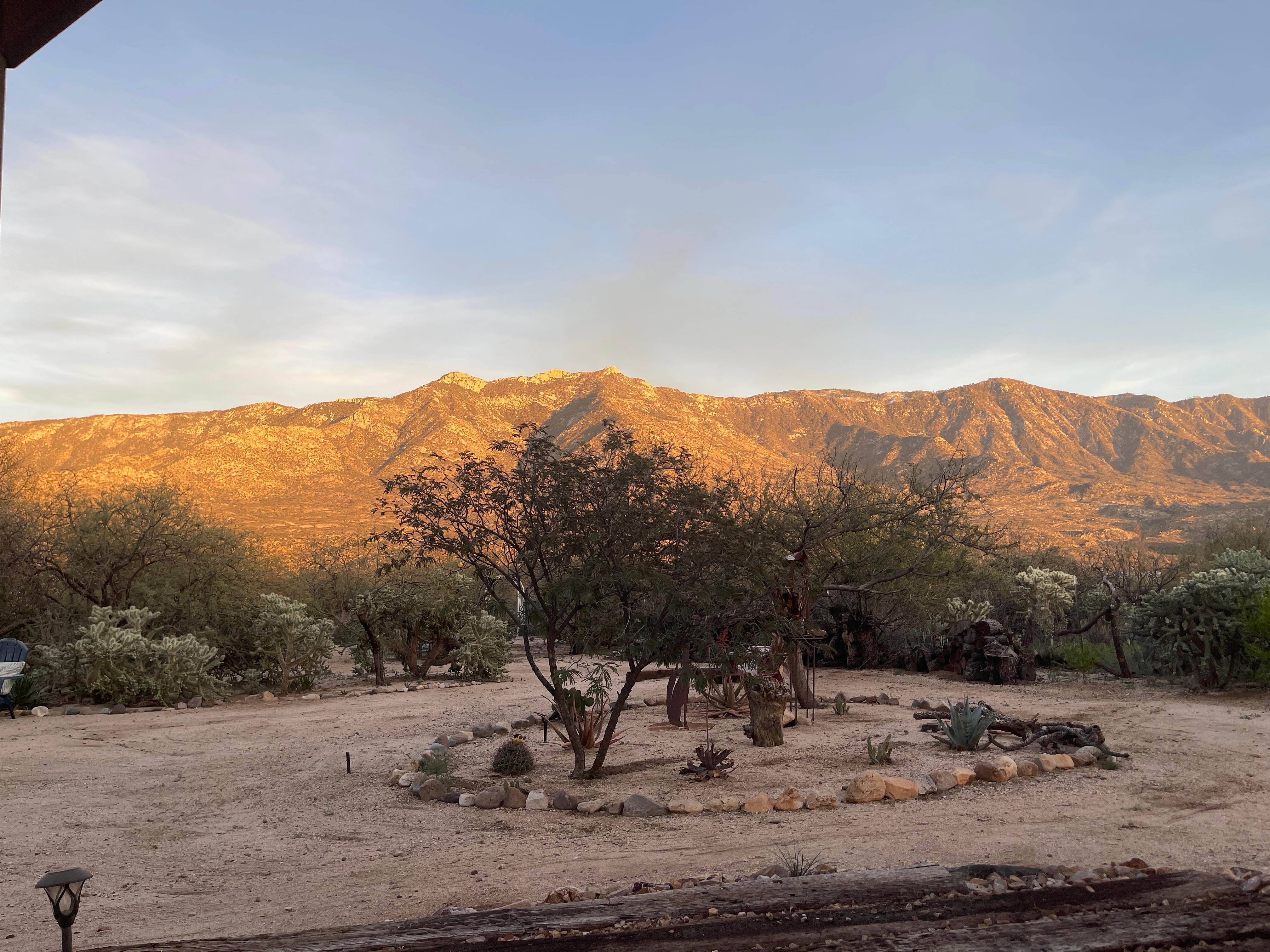 The sun going down and shining on the foothills from our recliner
