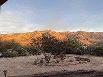 The sun going down and shining on the foothills from our recliner