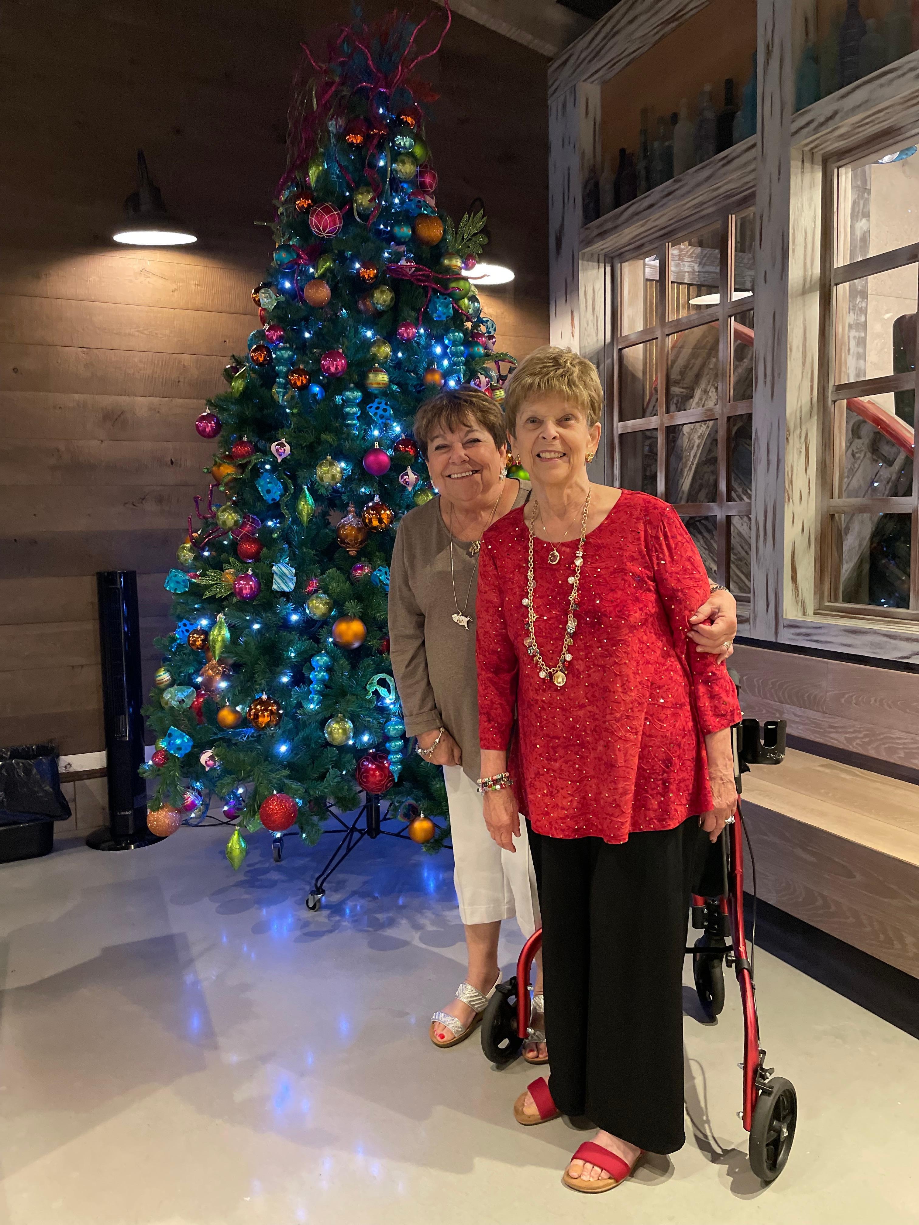 My sister in front of one of the many beautifully decorated trees.  Very festive.