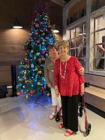 My sister in front of one of the many beautifully decorated trees. Very festive.