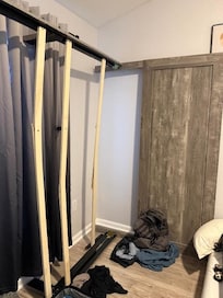 Bed frame of broken bed propped against wall