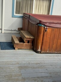 Broken step on hot tub access steps with rusty screws sticking out