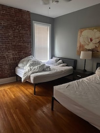 Bedroom #1 with unmade beds