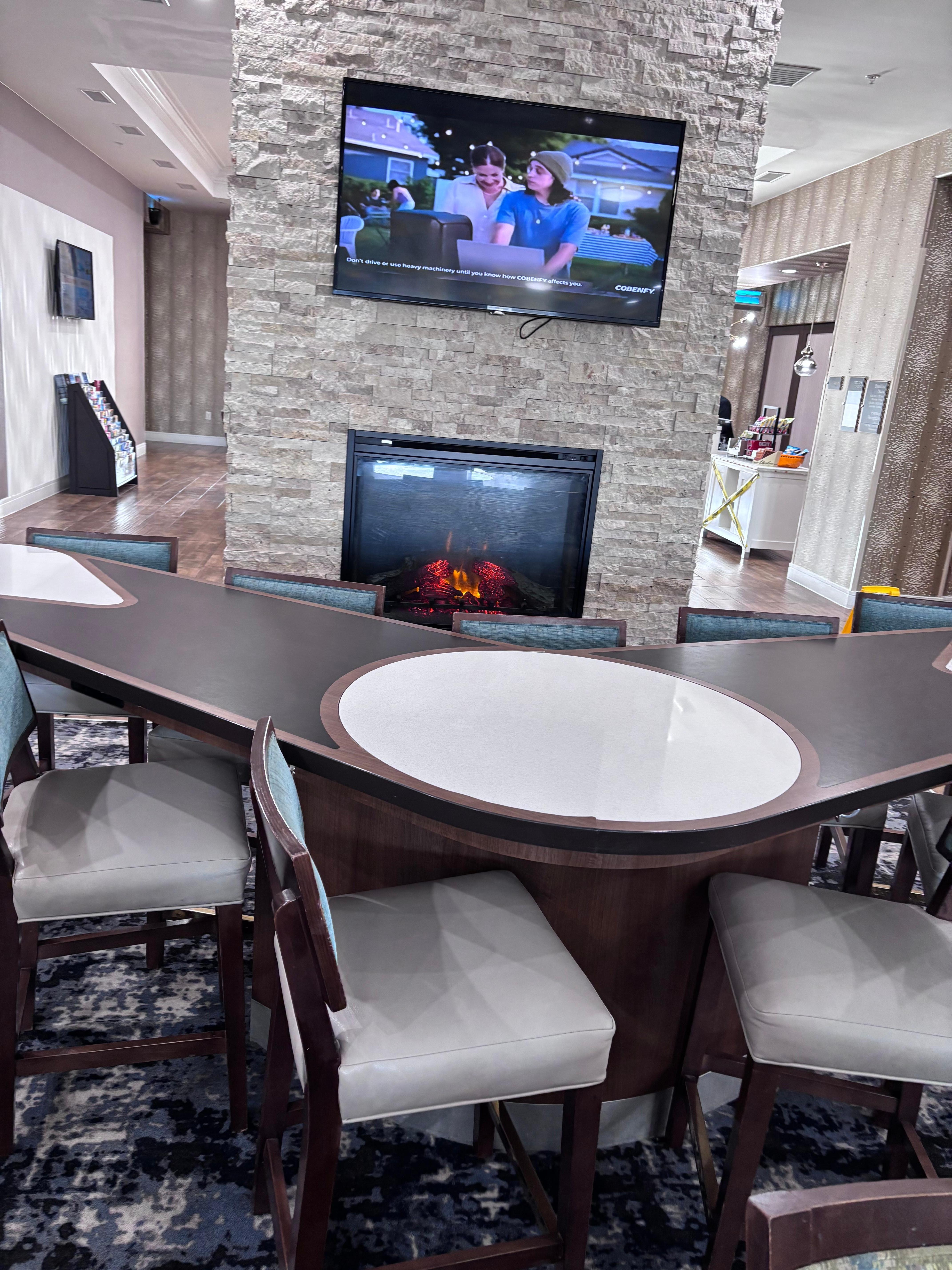 Buffet Breakfast area with a Beautiful Ambiance Fire Place Wall with  Morning News of the Island !