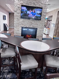 Buffet Breakfast area with a Beautiful Ambiance Fire Place Wall with  Morning News of the Island !