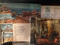 There is a display case showing historical artifacts and articles featuring the Hotel Majestic, and this giant postcard for the Cliff House.