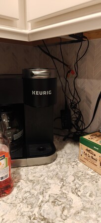 View of wire hanging behind coffee maker