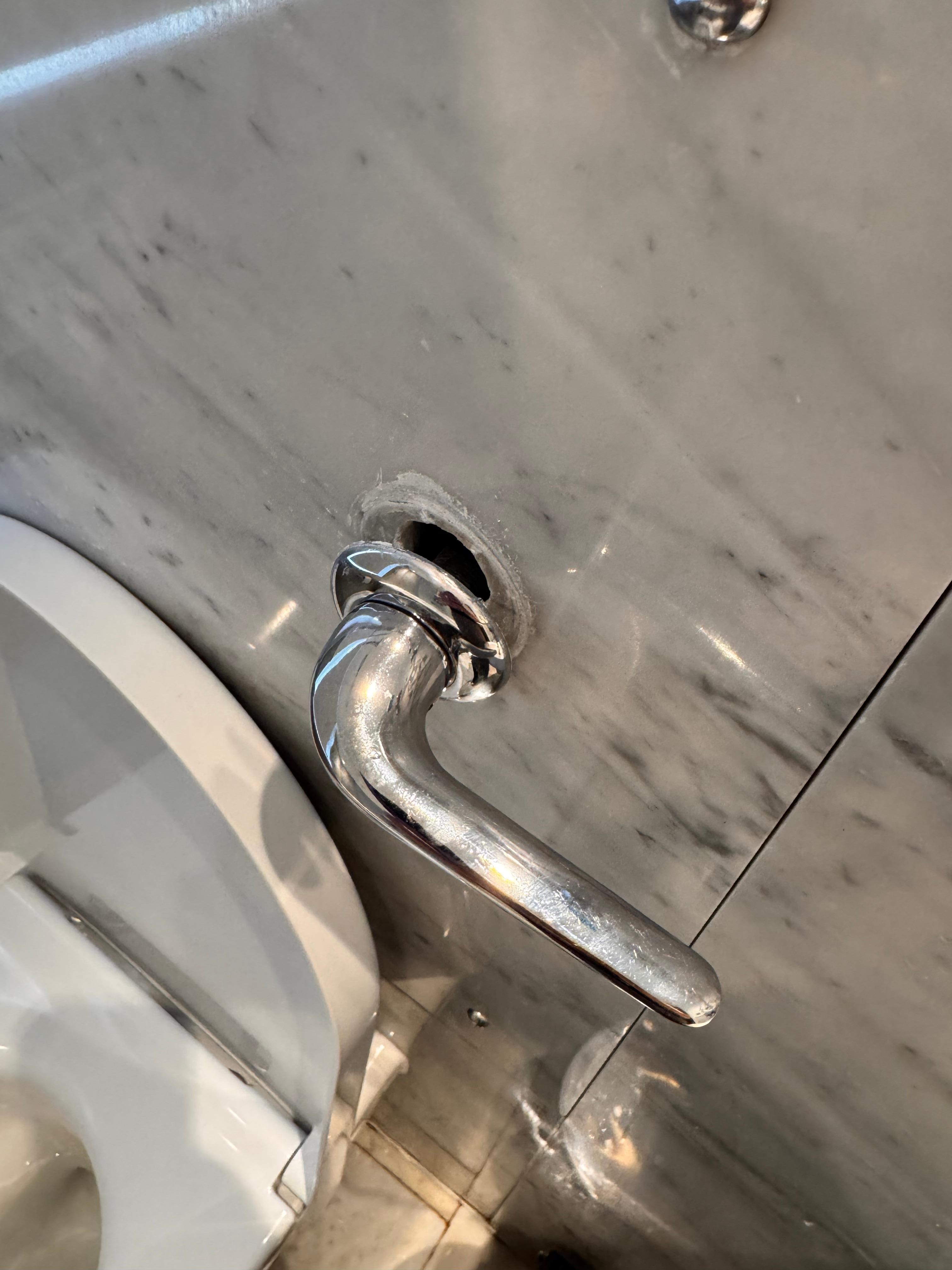 Toilet flush hanging off the wall