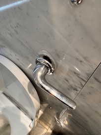 Toilet flush hanging off the wall