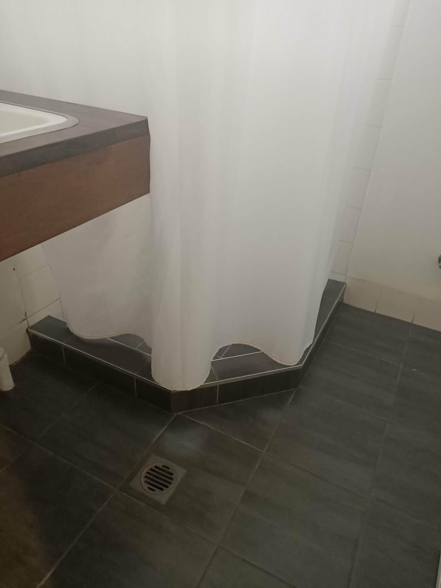 The short shower curtain - not practical 