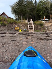View of stairs from beach in front of cabin.