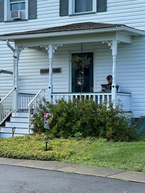 My cute dad reading on the porch.