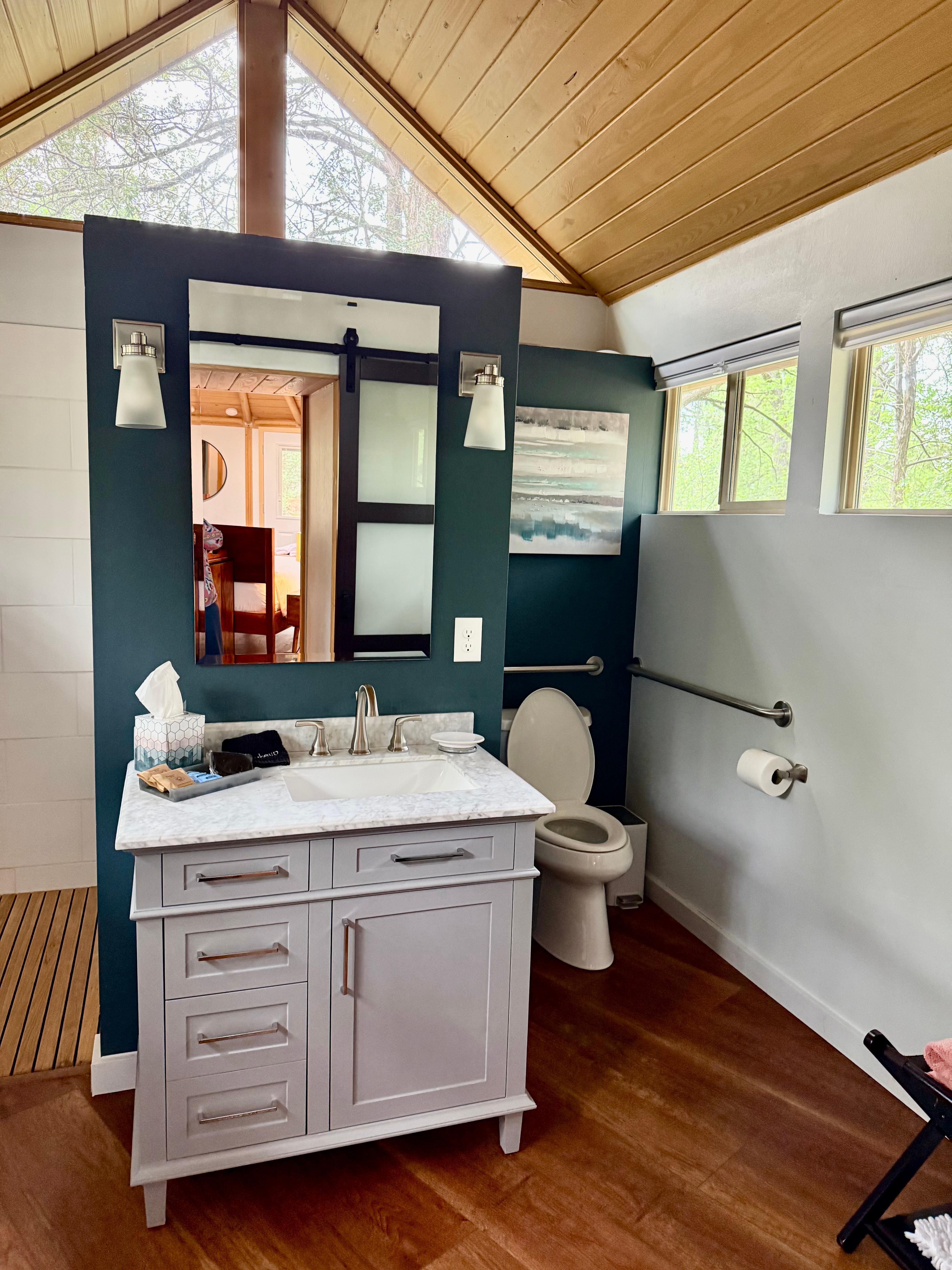 Large modern bathroom and shower area with robes, bath, and spa towels. 