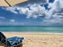 Sun loungers and umbrellas provided on the beach.