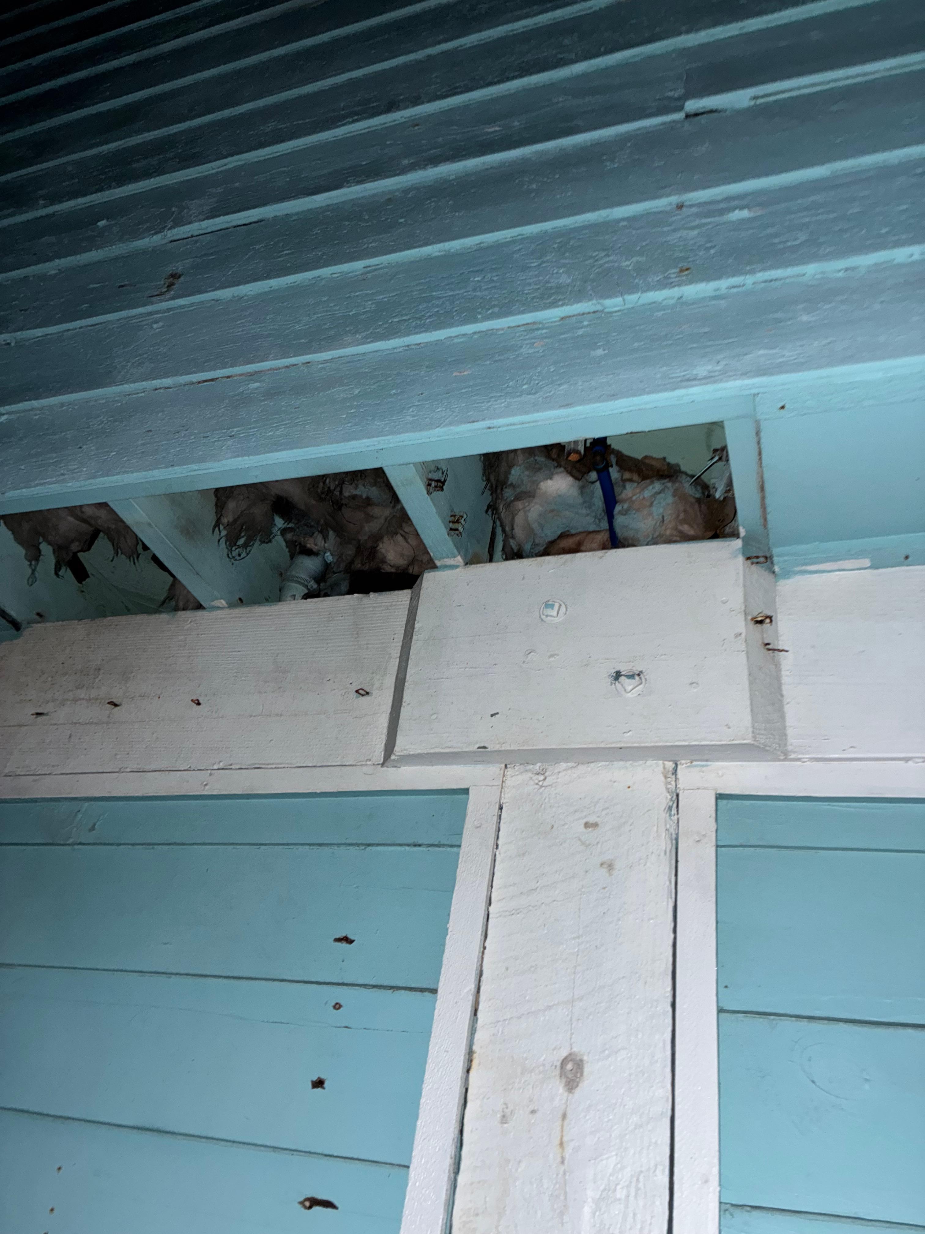 Insulation falling out on the side of the house